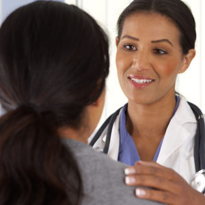 close up of african american doctor talking to female patient
