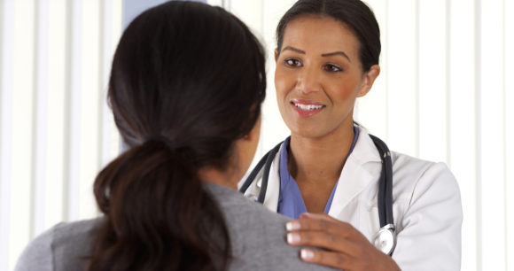 close up of african american doctor talking to female patient