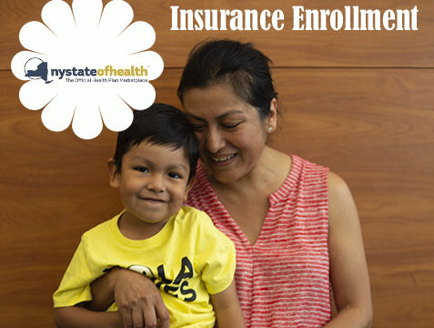 Mom holds smiling child with sign above head that reads insurance enrollment