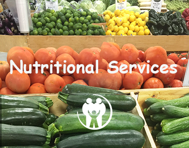 vegetable stand featuring green zucchini squash red tomatoes lemon and limes